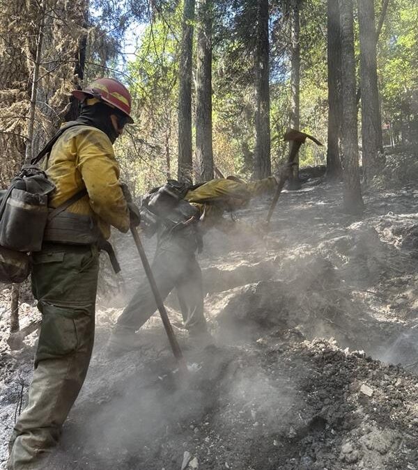 Minimal smoke visible from East Evans Creek Fire as crews continue to mop-up and strengthen control lines; evacuation levels downgraded